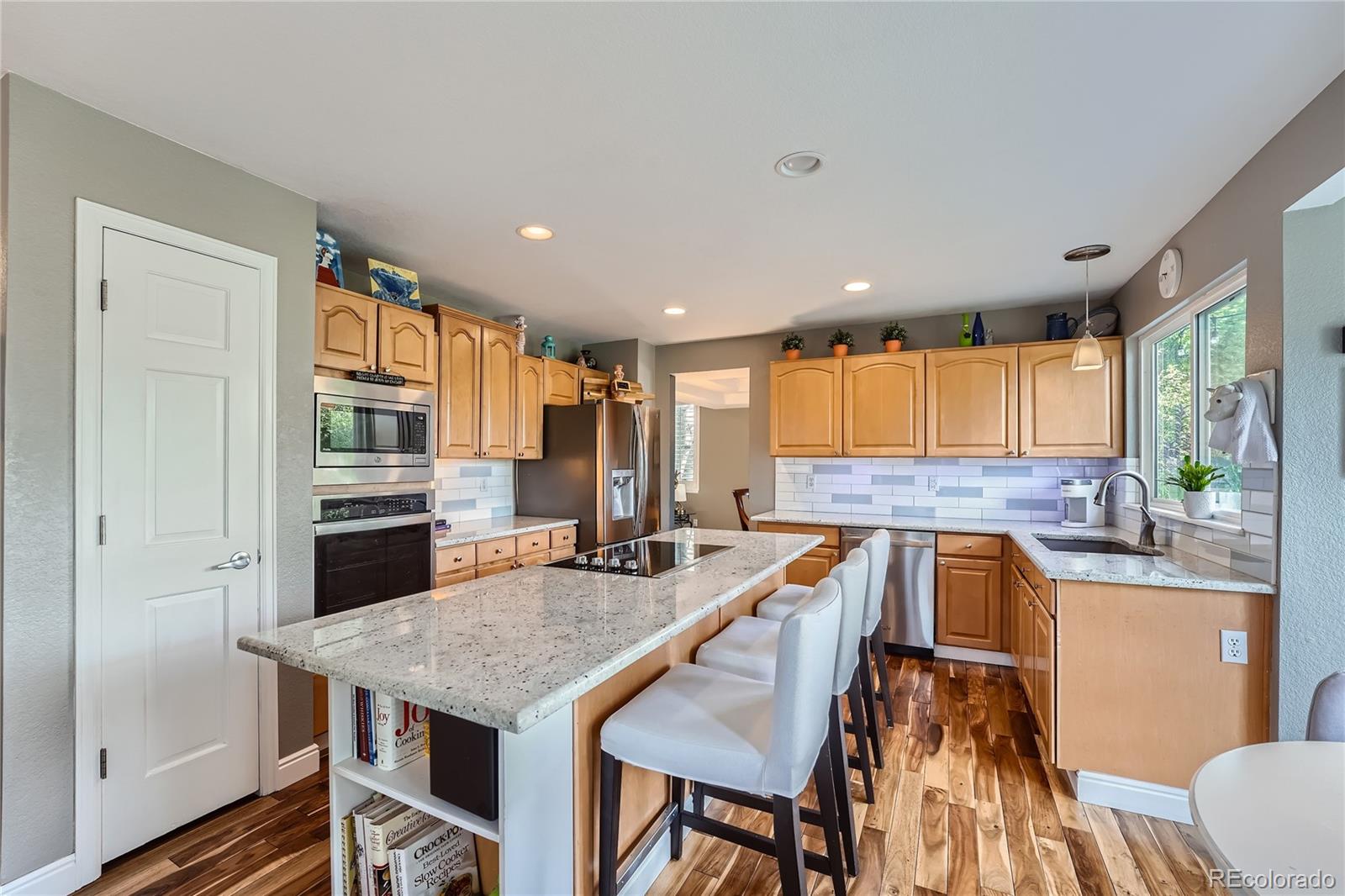9538 La Quinta Drive Lone Tree, CO 80124 - Photo 12 of 41 a kitchen with a table chairs sink and refrigerator