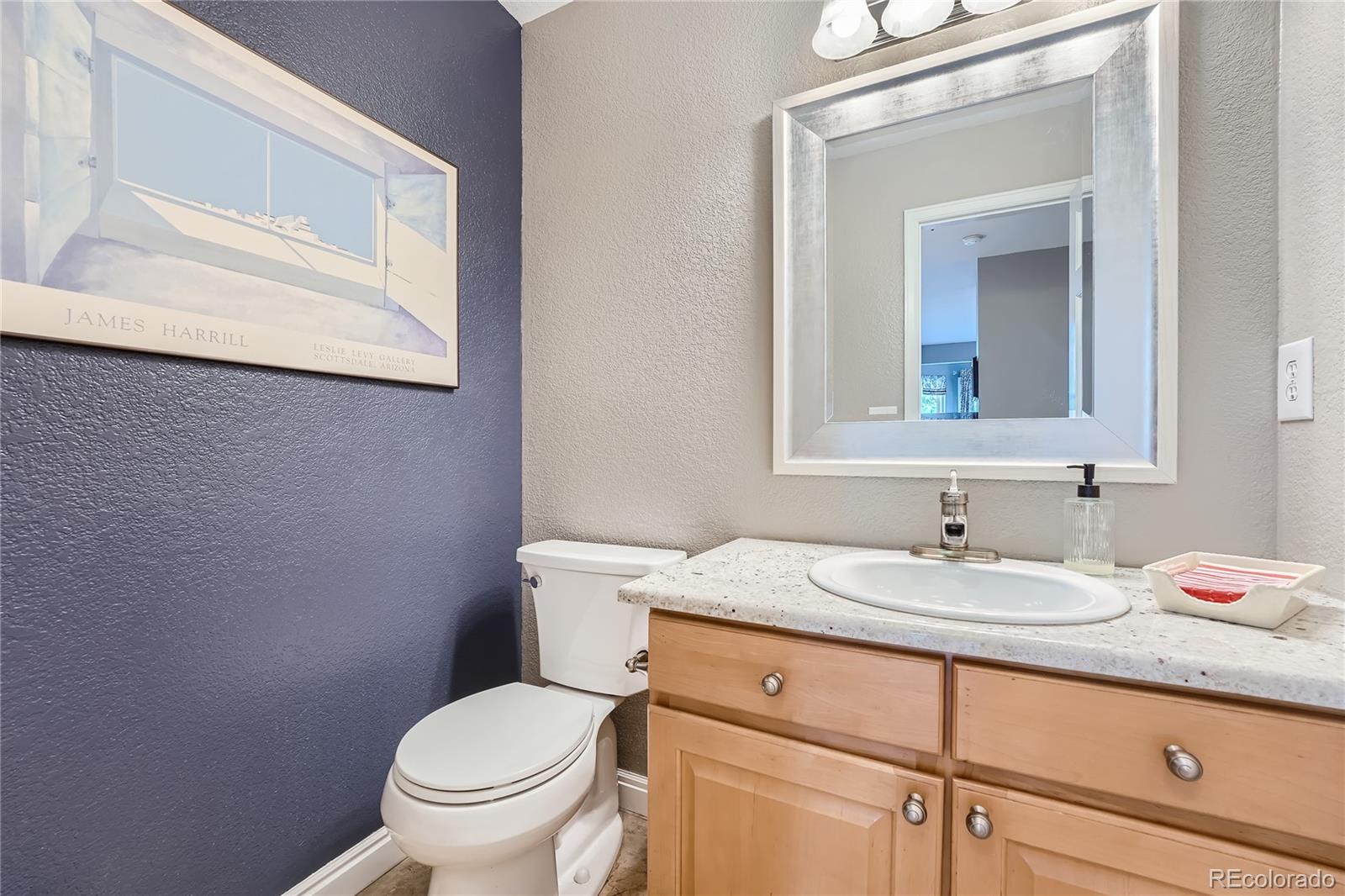 9538 La Quinta Drive Lone Tree, CO 80124 - Photo 20 of 41 a bathroom with a granite countertop toilet sink and mirror