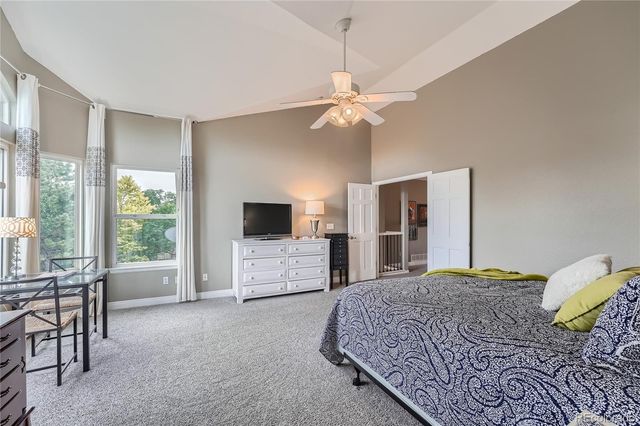 a bedroom with a large bed and a flat screen tv