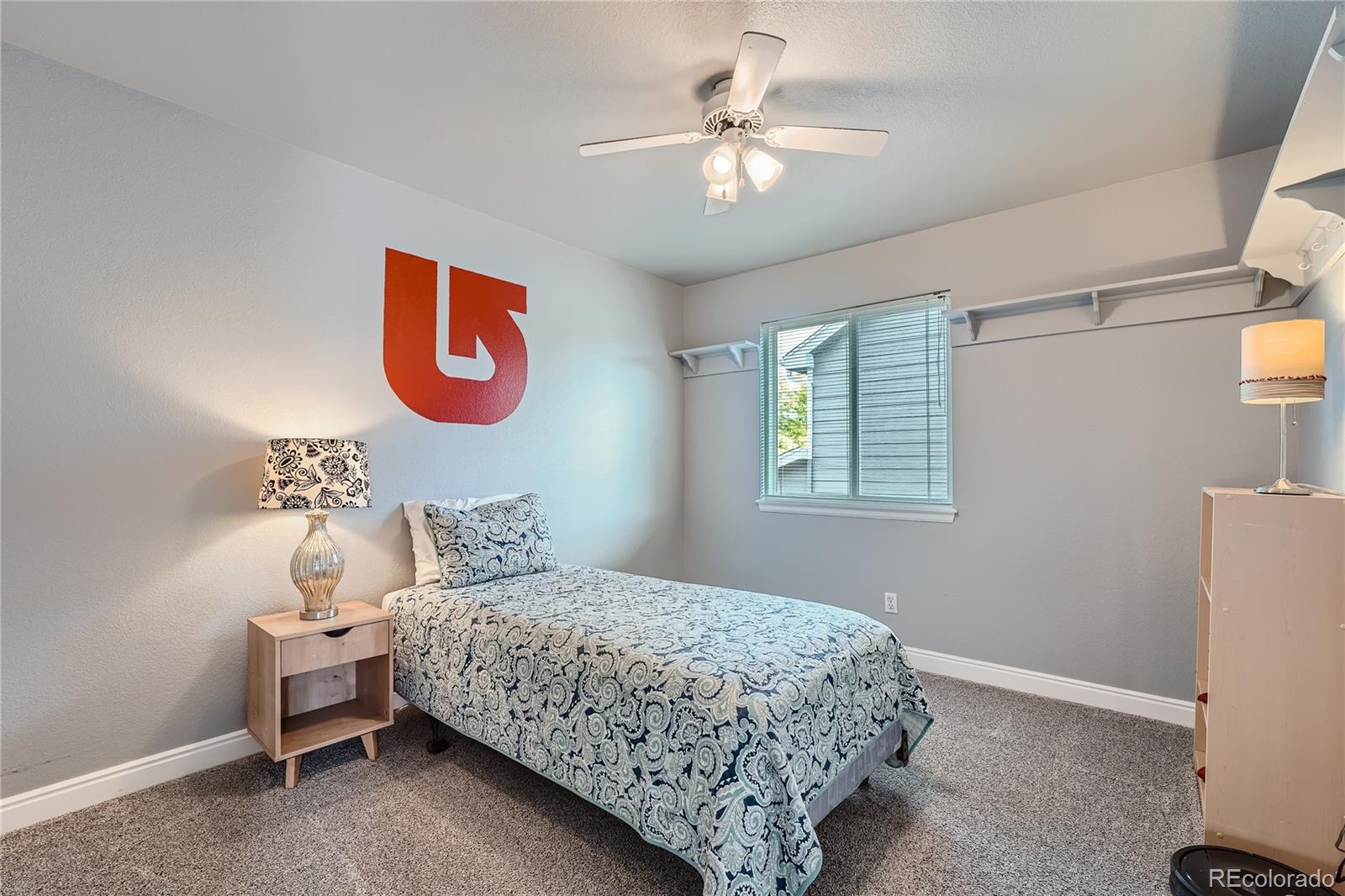 9538 La Quinta Drive Lone Tree, CO 80124 - Photo 26 of 41 a bedroom with a bed and a chandelier