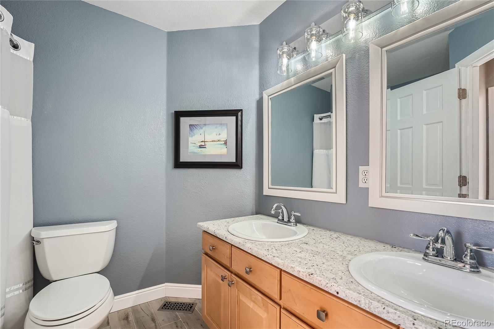 9538 La Quinta Drive Lone Tree, CO 80124 - Photo 28 of 41 a bathroom with a granite countertop sink vanity mirror and toilet