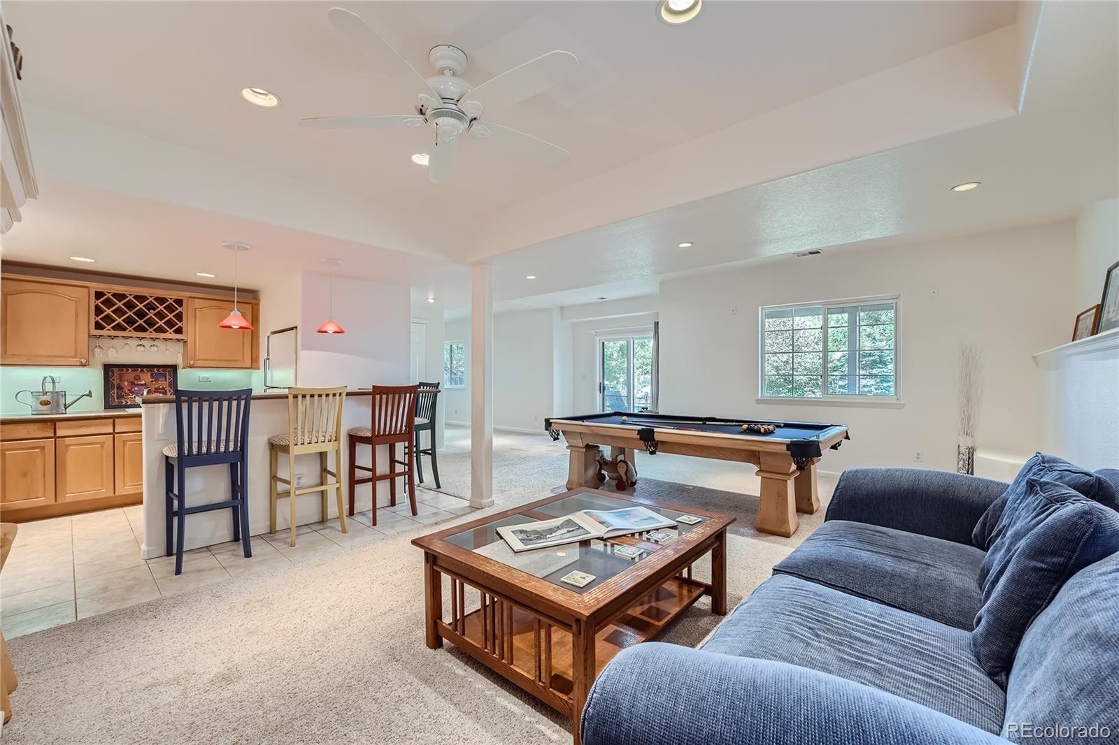 9538 La Quinta Drive Lone Tree, CO 80124 - Photo 30 of 41 a living room with furniture a table and kitchen view