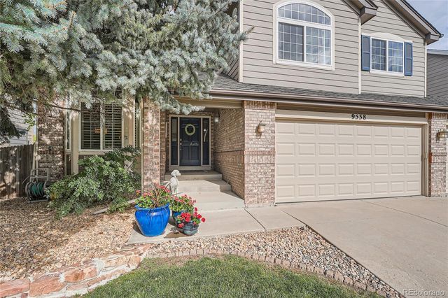 a view of a house with potted plants