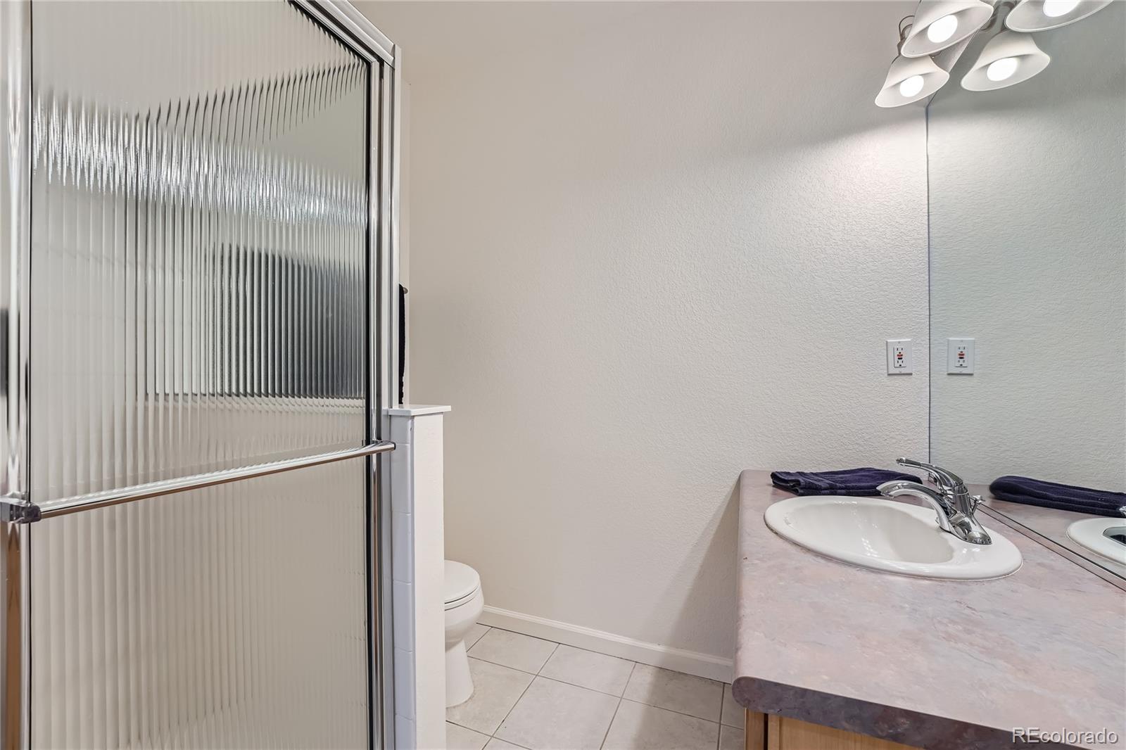 9538 La Quinta Drive Lone Tree, CO 80124 - Photo 32 of 41 a bathroom with a sink and mirror