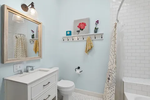 a view of bathroom with a sink and a mirror