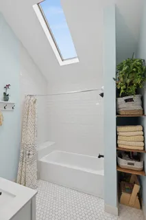 a bathroom with a bathtub and shower