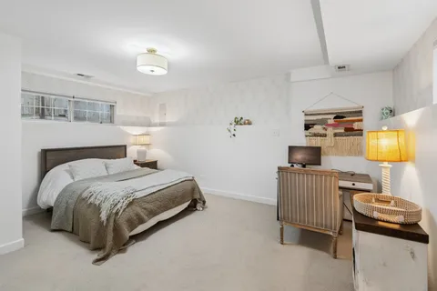 a bedroom with a bed and a lamp