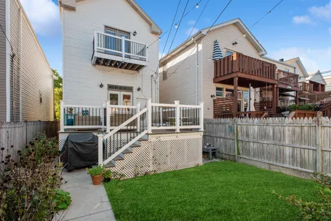 a view of a house with wooden fence