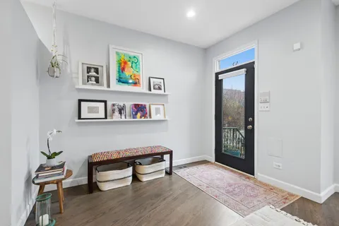 a view of room with lounge chair and wooden floor