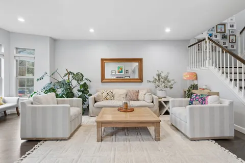 a living room with furniture and a potted plant