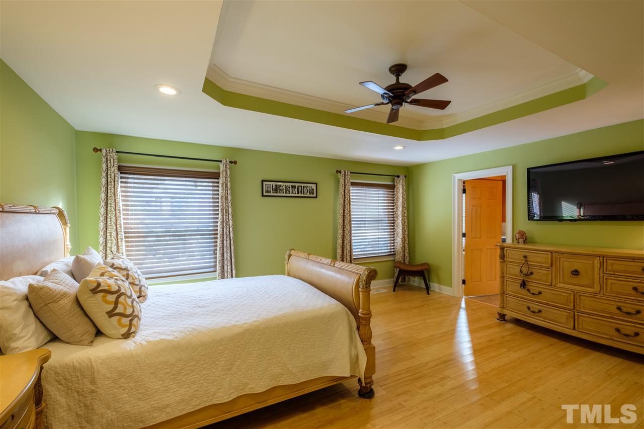 720 Malbay Lane Raleigh, NC 27615 - Photo 8 of 25 a bedroom with a bed and a tv on the dresser
