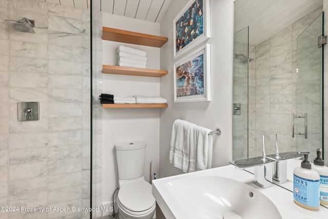 a bathroom with a sink a toilet and shower curtain
