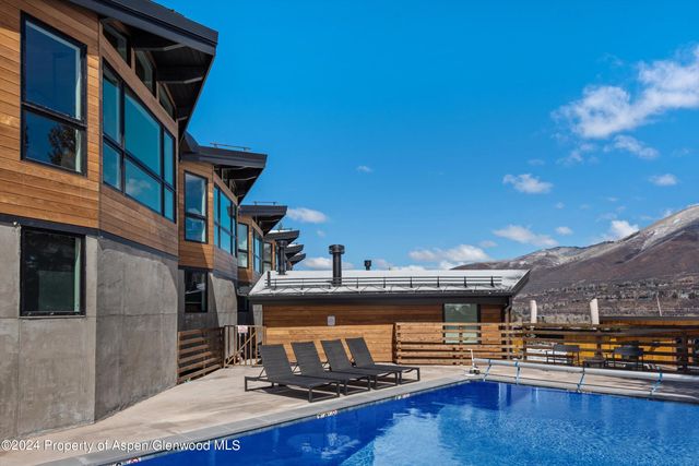 a view of pool with seating area and barbeque oven