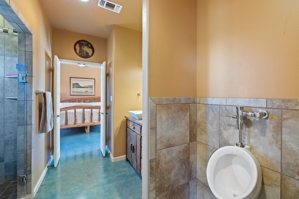 1292 Upper Turtle Creek Road Kerrville, TX 78028 - Photo 29 of 40 Full bath featuring vanity, ensuite bath, and a stall shower