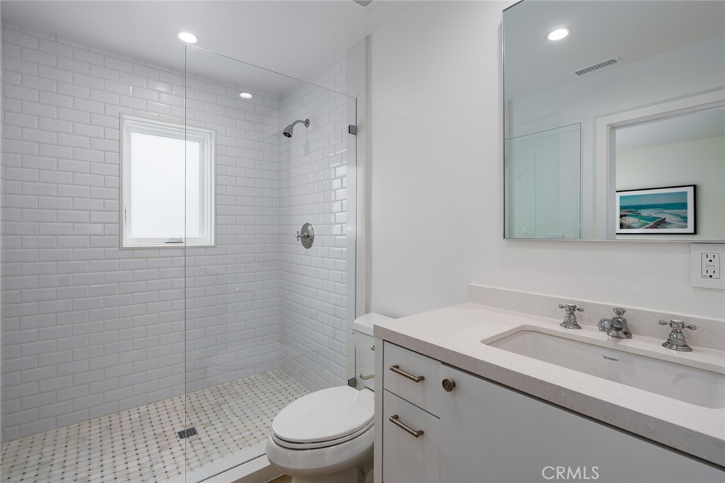 480 Morning Canyon Road Corona del Mar, CA 92625 - Photo 12 of 33 a bathroom with a granite countertop sink toilet a mirror and shower