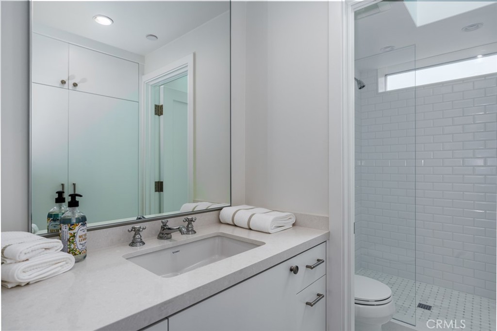 480 Morning Canyon Road Corona del Mar, CA 92625 - Photo 15 of 33 a bathroom with a granite countertop sink a toilet and a mirror