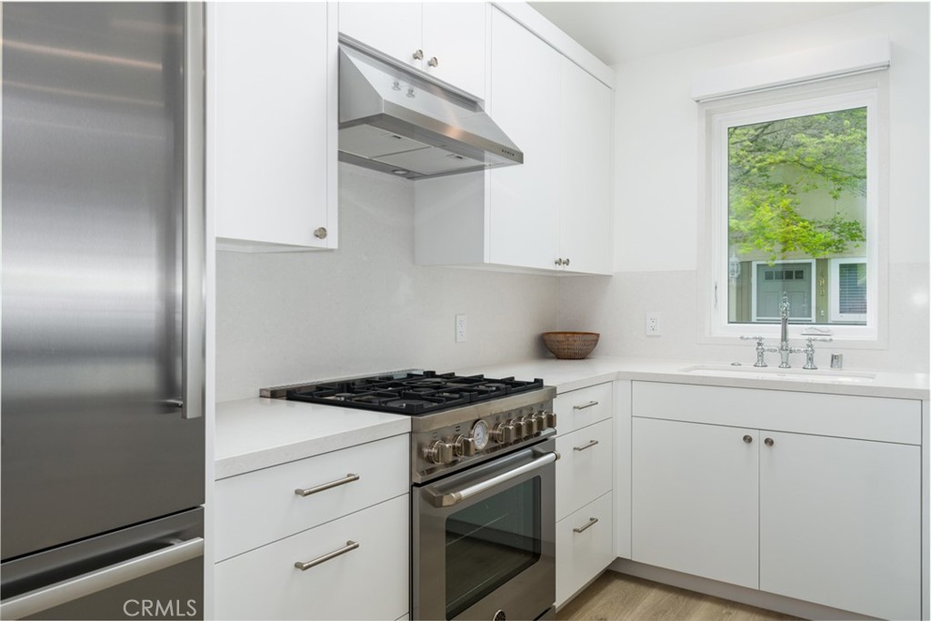 480 Morning Canyon Road Corona del Mar, CA 92625 - Photo 7 of 33 a kitchen with cabinets appliances and a window