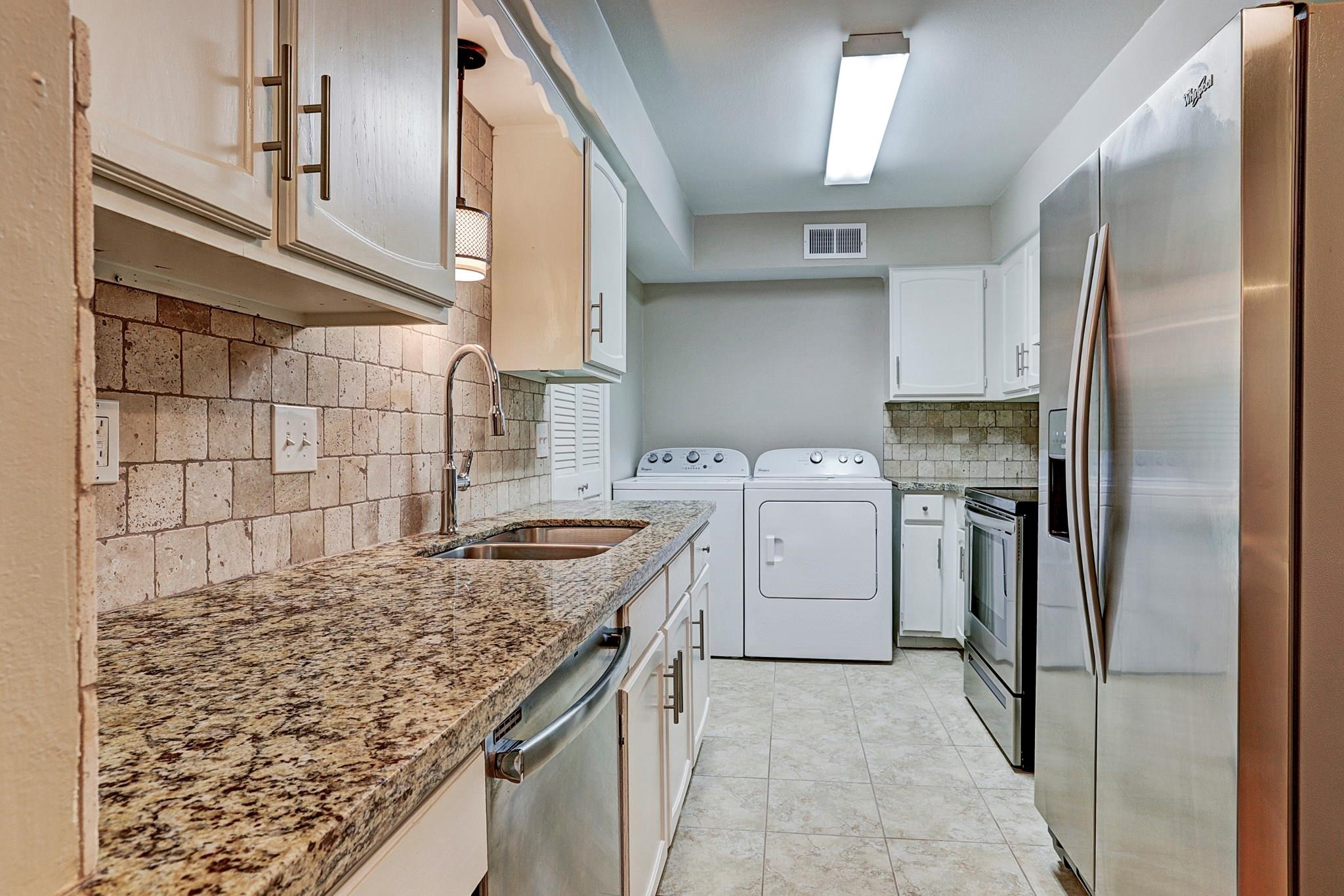 a kitchen with a sink stove and refrigerator