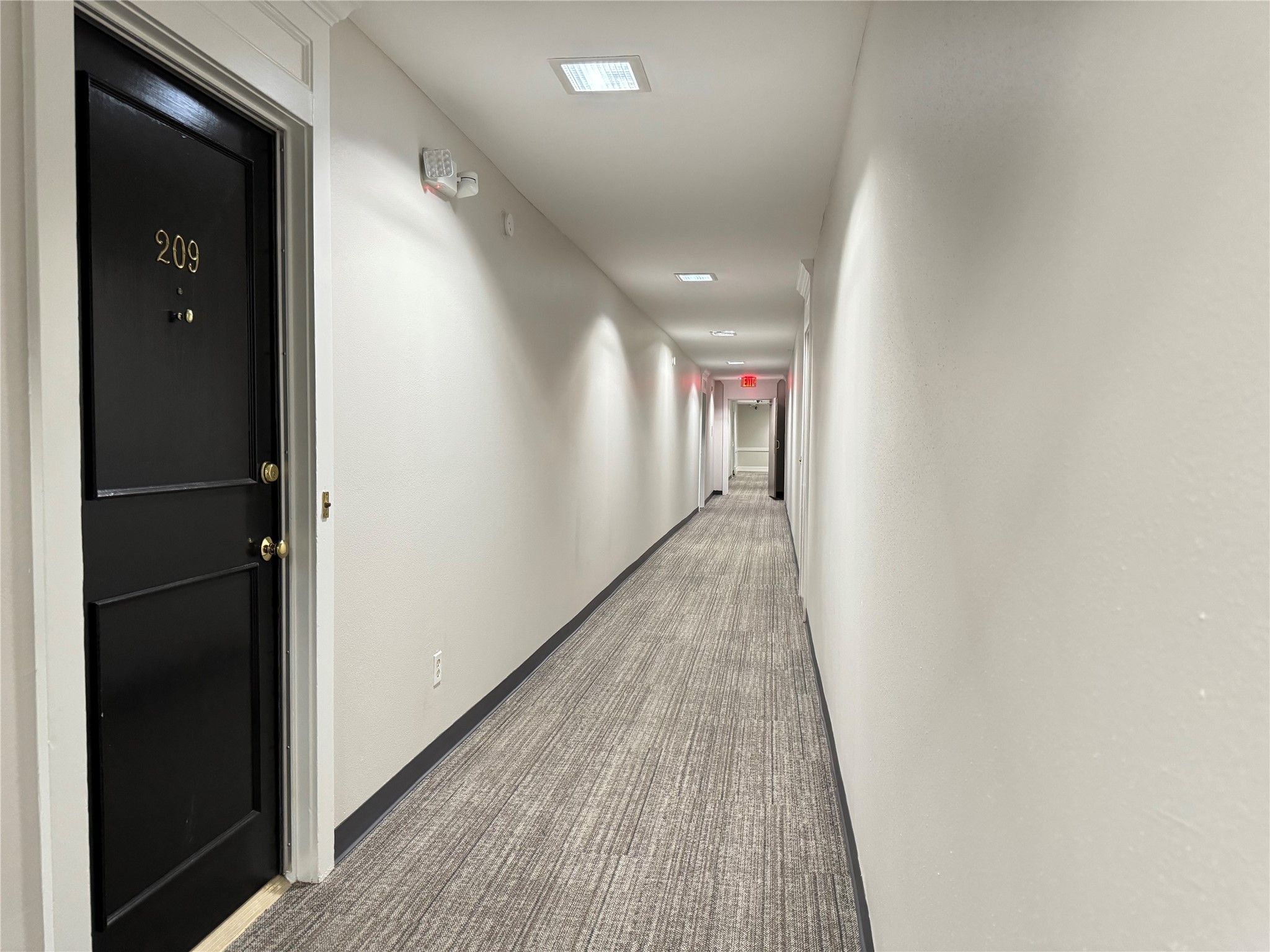 357 North Post Oak Lane, Unit 209 Houston, TX 77024 - Photo 13 of 20 a view of hallway with wooden floor