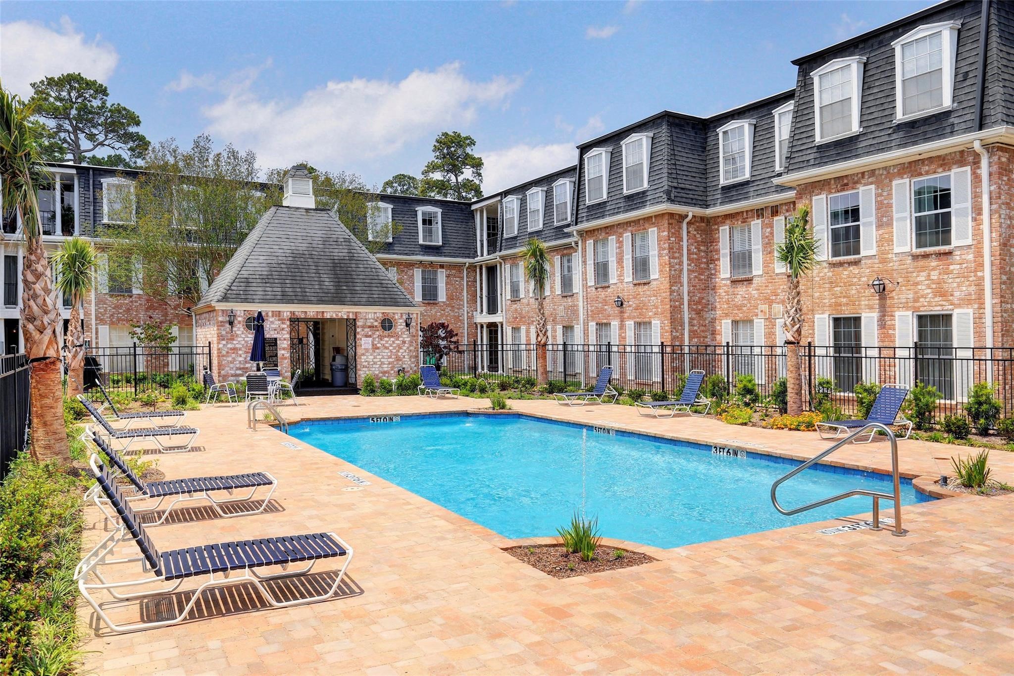 357 North Post Oak Lane, Unit 209 Houston, TX 77024 - Photo 17 of 20 a view of swimming pool with outdoor seating and house in the background