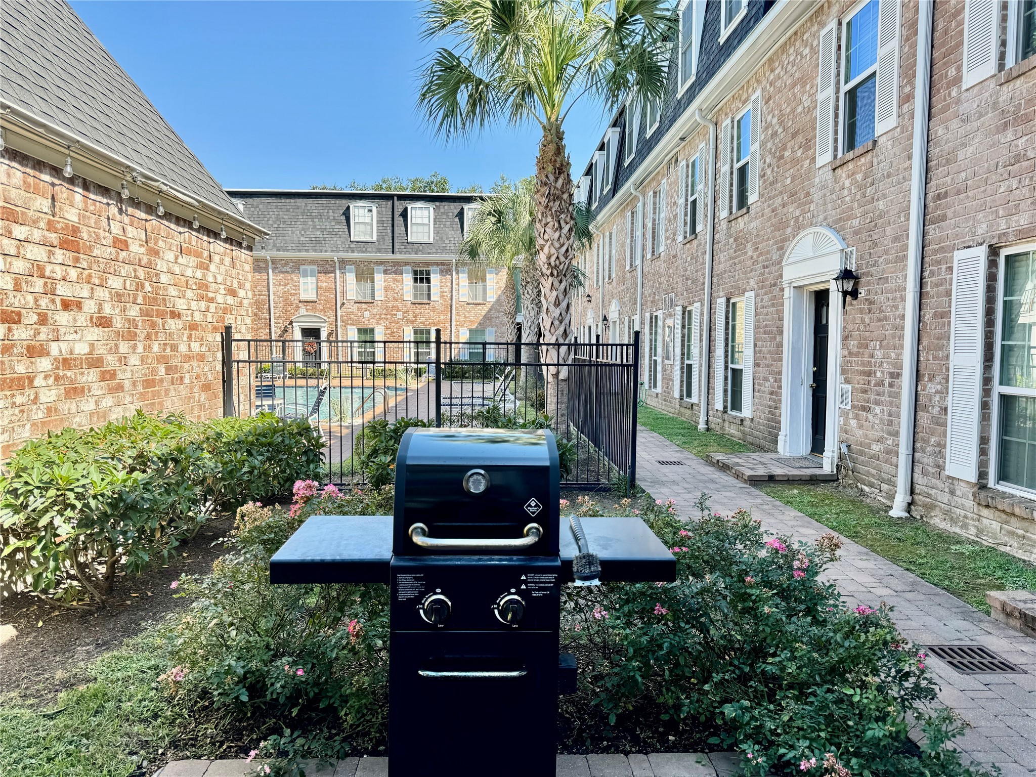 357 North Post Oak Lane, Unit 209 Houston, TX 77024 - Photo 18 of 20 a view of a patio with table and chairs and potted plants