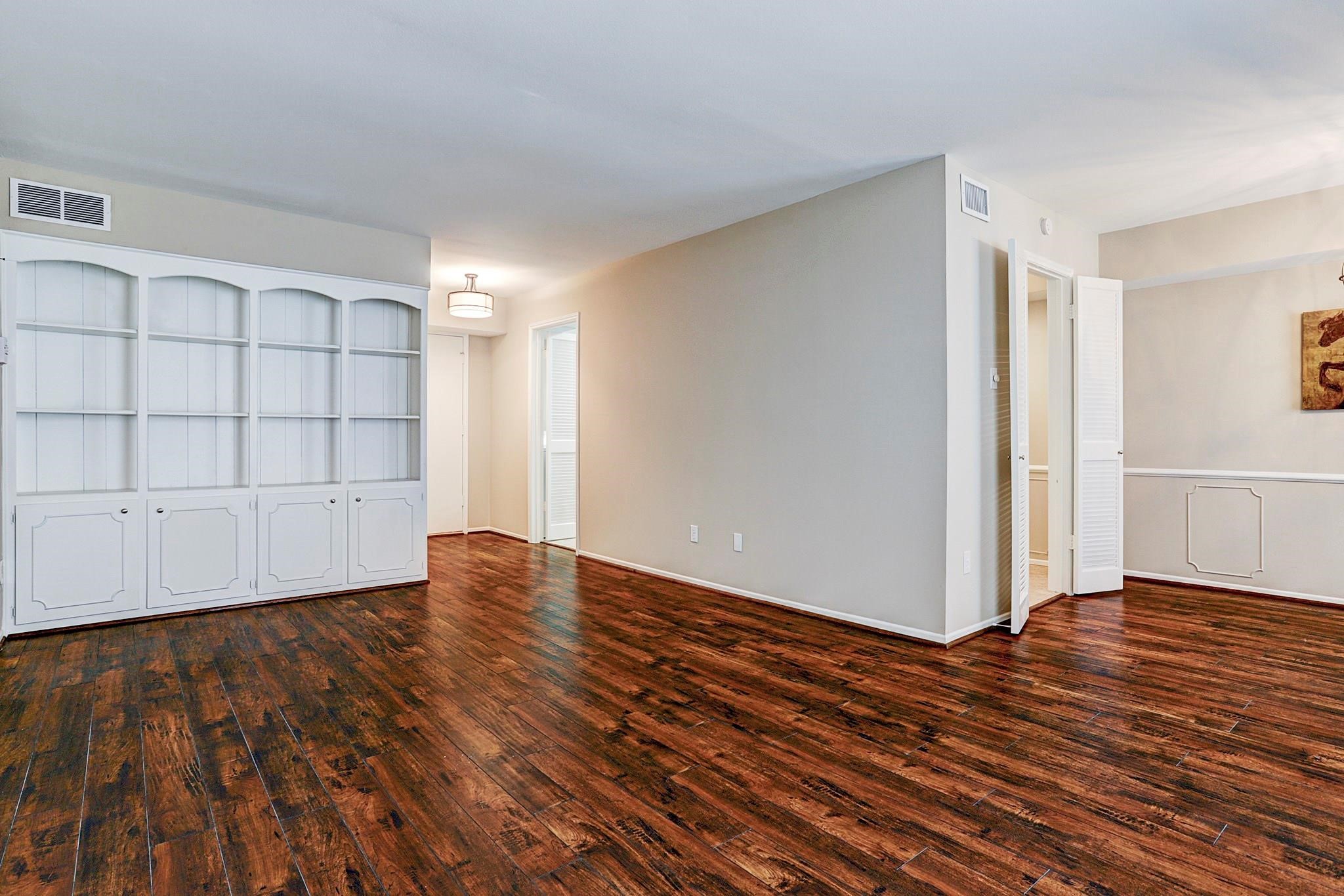 357 North Post Oak Lane, Unit 209 Houston, TX 77024 - Photo 8 of 20 a view of an empty room with wooden floor and closet