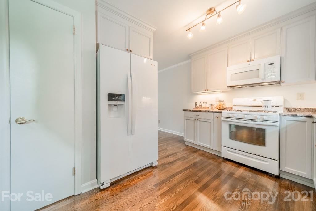 5330 Valley Forge Road Charlotte, NC 28210 - Photo 12 of 27 a kitchen with white cabinets and white appliances