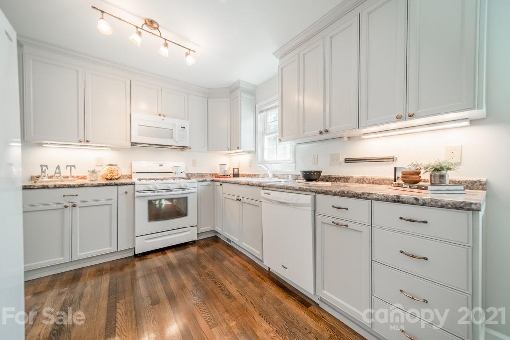 5330 Valley Forge Road Charlotte, NC 28210 - Photo 10 of 27 a kitchen with granite countertop white cabinets and white appliances
