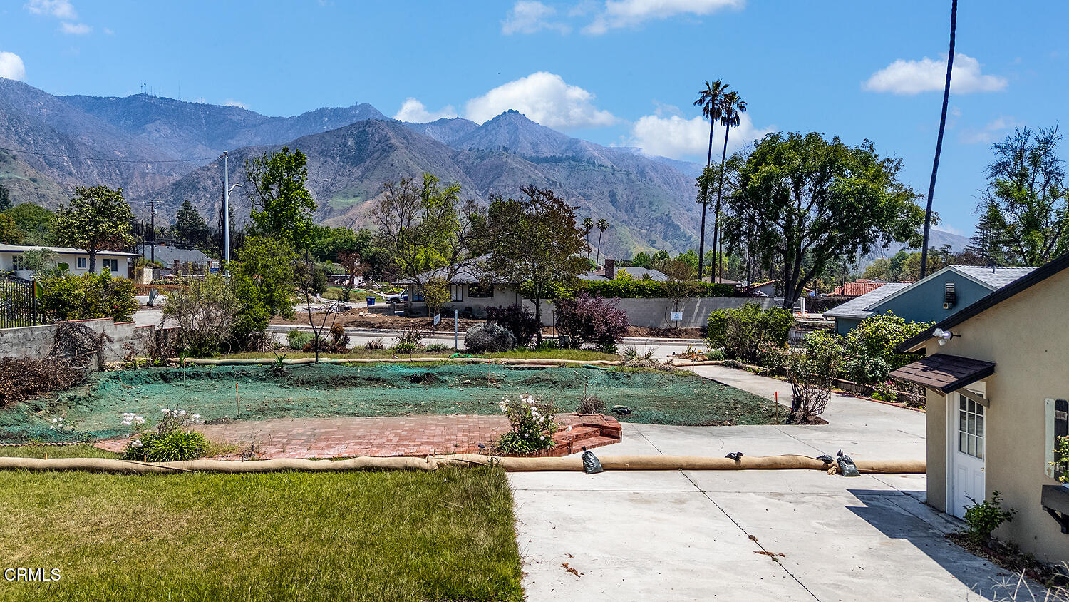 a view of a house with a garden and a yard
