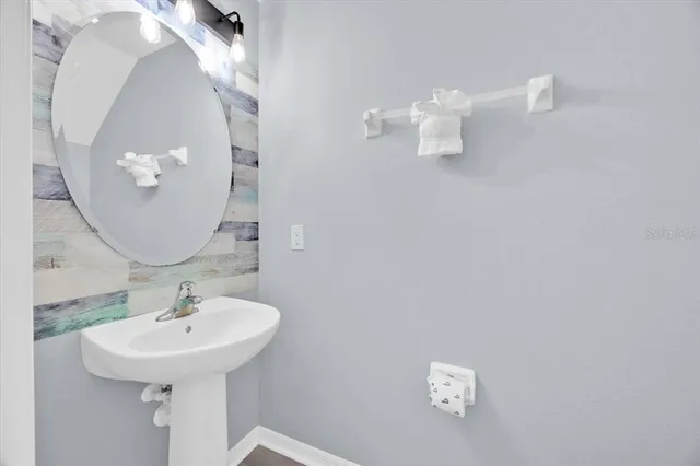 a bathroom with a sink a mirror and vanity
