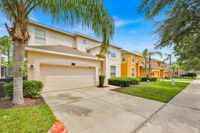 a front view of a house with a garden and garage