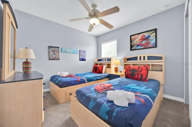 a bedroom with two beds and painting on the wall