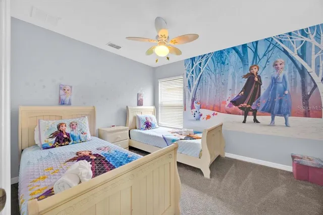 a bedroom with furniture and a chandelier