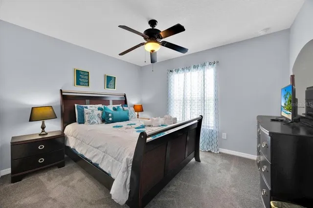 a bedroom with a bed and a chandelier