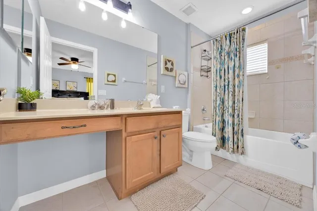 a bathroom with a double vanity sink toilet and shower