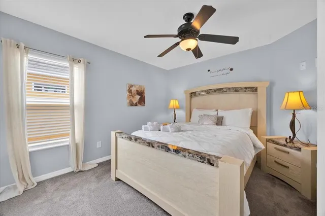 a bedroom with a bed and a chandelier