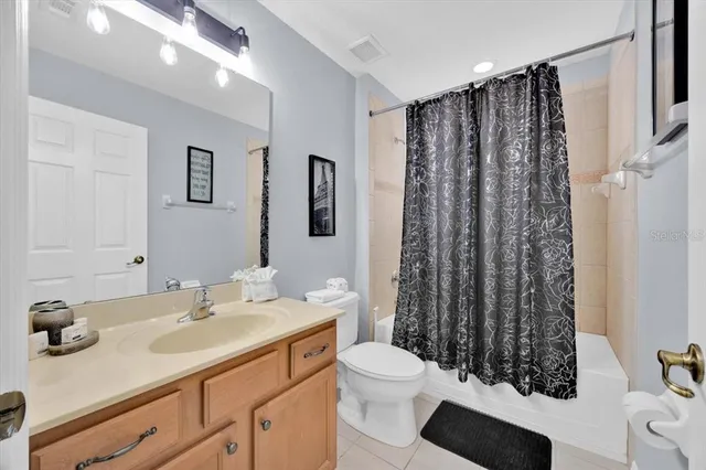 a bathroom with a sink a toilet a shower and a mirror