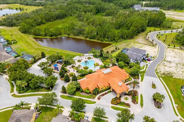an aerial view of a house a yard and a lake view