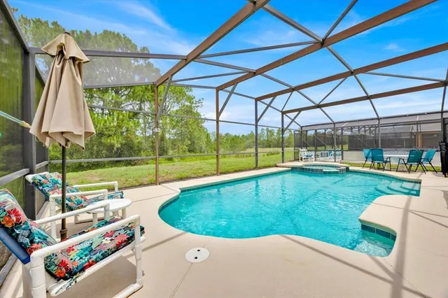a view of backyard with swimming pool