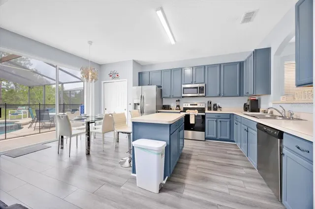 a large kitchen with a table and chairs