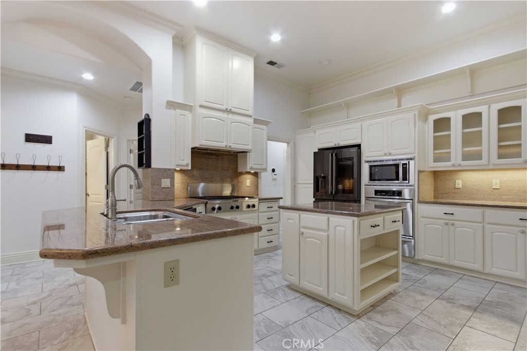 2144 King Arthur Court Merced, CA 95340 - Photo 13 of 66 a kitchen with stainless steel appliances granite countertop a stove top oven a sink a microwave and refrigerator