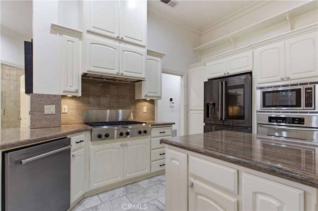 2144 King Arthur Court Merced, CA 95340 - Photo 14 of 66 a kitchen with stainless steel appliances granite countertop a stove a sink and a microwave