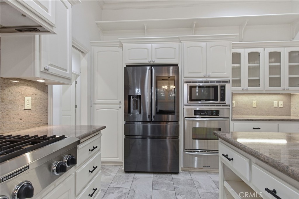 2144 King Arthur Court Merced, CA 95340 - Photo 15 of 66 a kitchen with stainless steel appliances granite countertop a stove a refrigerator and a sink
