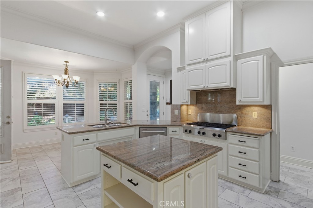 2144 King Arthur Court Merced, CA 95340 - Photo 16 of 66 a kitchen with stainless steel appliances granite countertop a sink and a stove