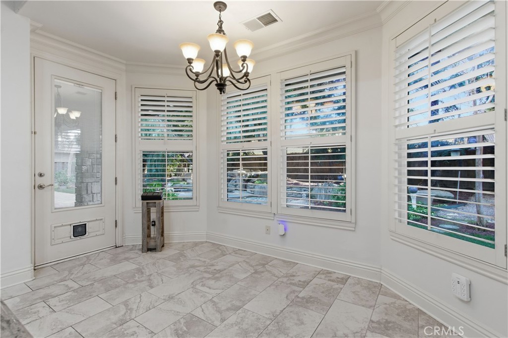 2144 King Arthur Court Merced, CA 95340 - Photo 17 of 66 a view of a livingroom with a chandelier curtains and large windows