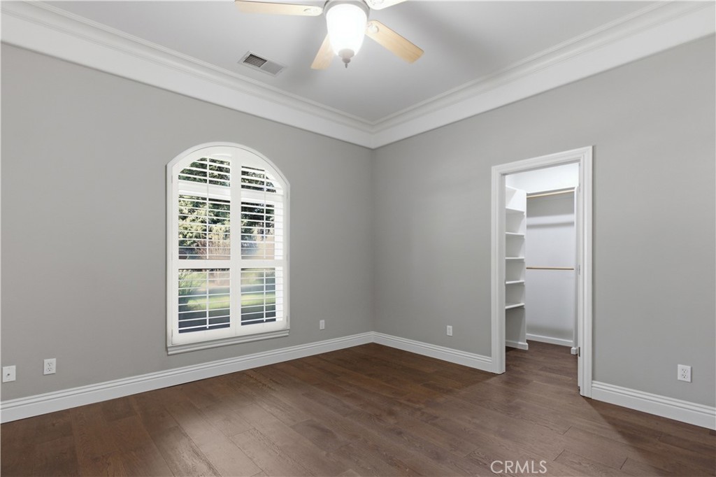 2144 King Arthur Court Merced, CA 95340 - Photo 31 of 66 an empty room with wooden floor chandelier and windows