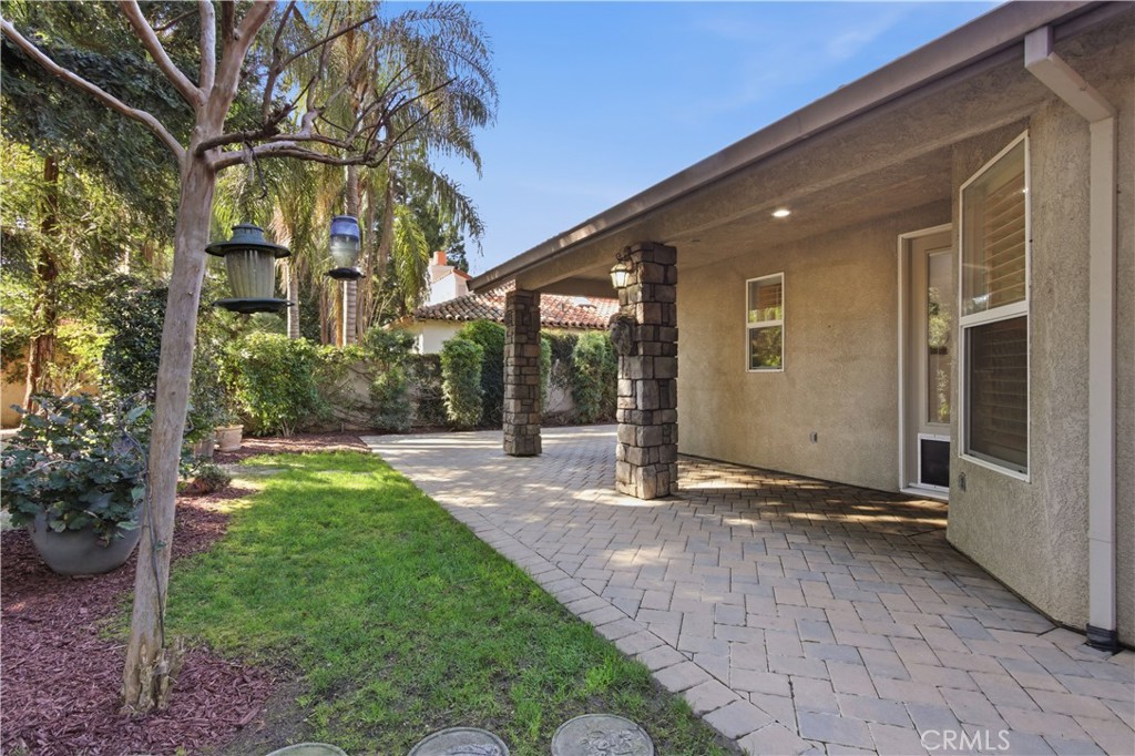 2144 King Arthur Court Merced, CA 95340 - Photo 50 of 66 a backyard of a house with table and chairs under an umbrella