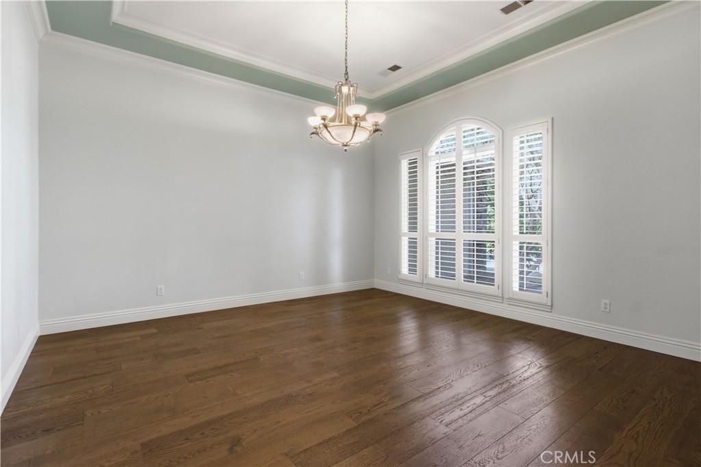 2144 King Arthur Court Merced, CA 95340 - Photo 9 of 66 a view of an empty room with wooden floor and a window