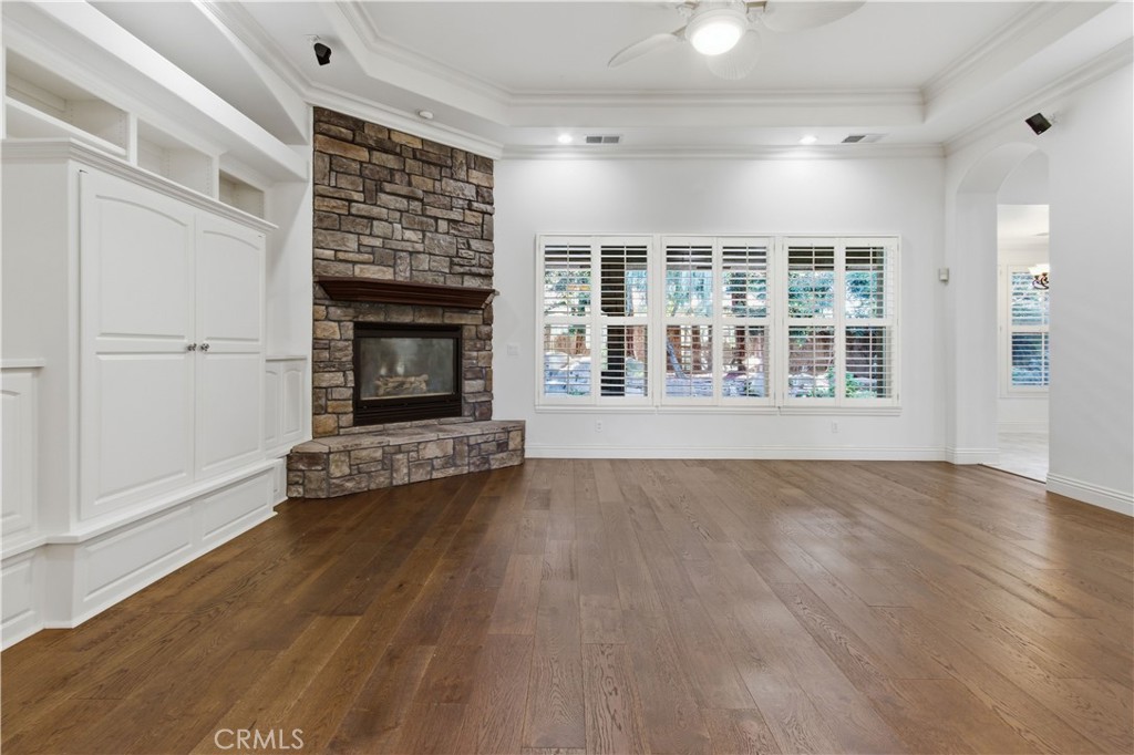 2144 King Arthur Court Merced, CA 95340 - Photo 10 of 66 an empty room with wooden floor fireplace and windows