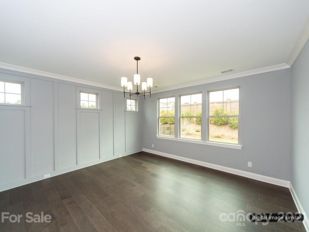 12031 Huntson Reserve Road Huntersville, NC 28078 - Photo 13 of 23 an empty room with wooden floor chandelier and windows